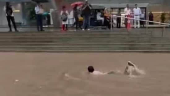Boy swims near Mumbai mall as rain floods city roads